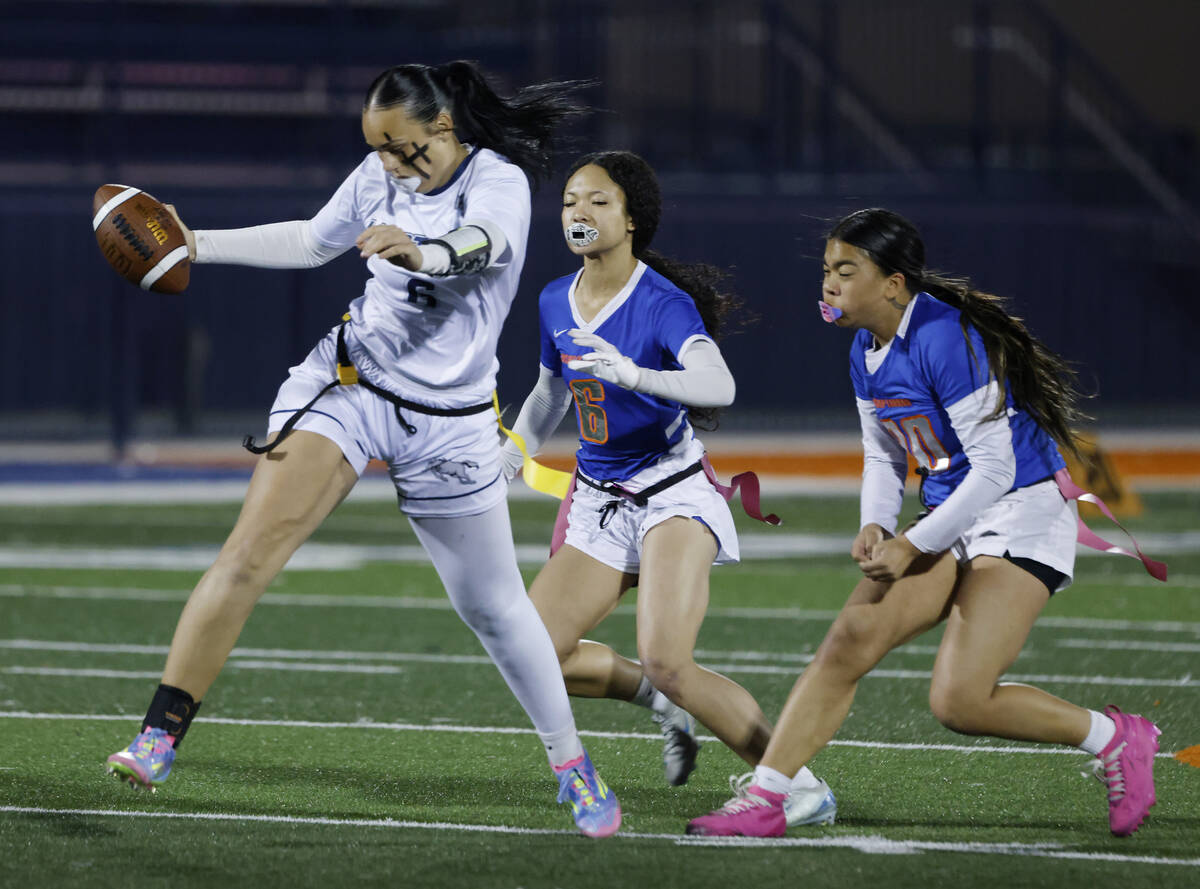 Shadow Ridge's quarterback Chloe Covington (6) evades a flag pull on a run by Bishop Gorma ...