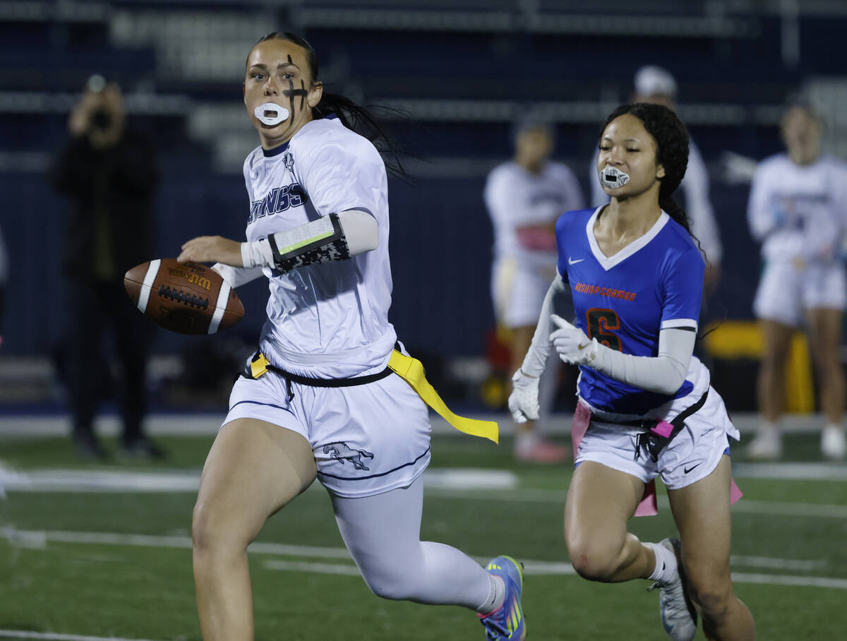 Shadow Ridge's quarterback Chloe Covington (6) sprints after evading a flag pull by Biisho ...
