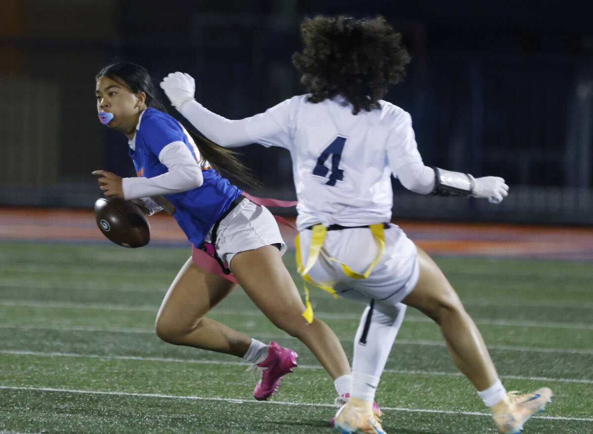 Bishop Gorman's quarterback Zehani English (00) evades a flag pull on a run by Shadow Ridg ...