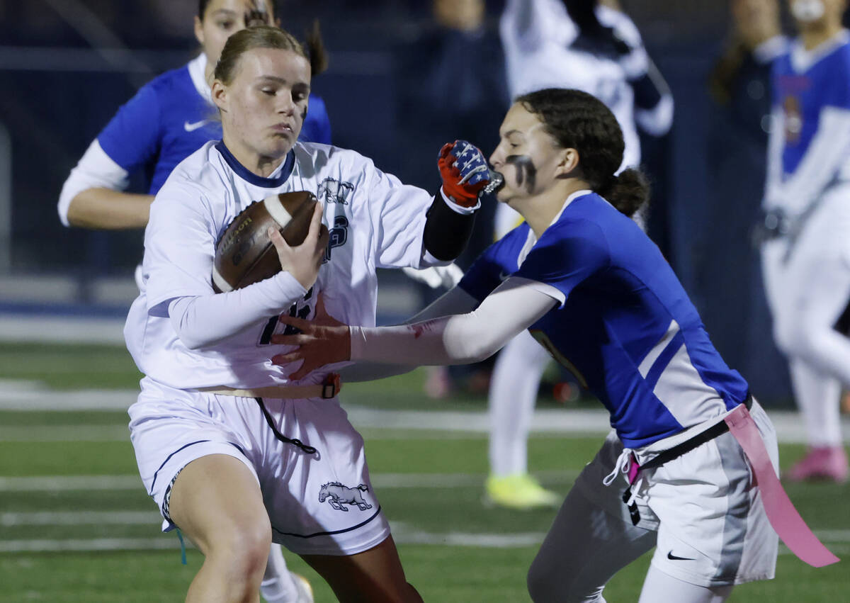 Shadow Ridge's running back Lily Christensen (16) evades a flag pull on a run by Bishop Go ...