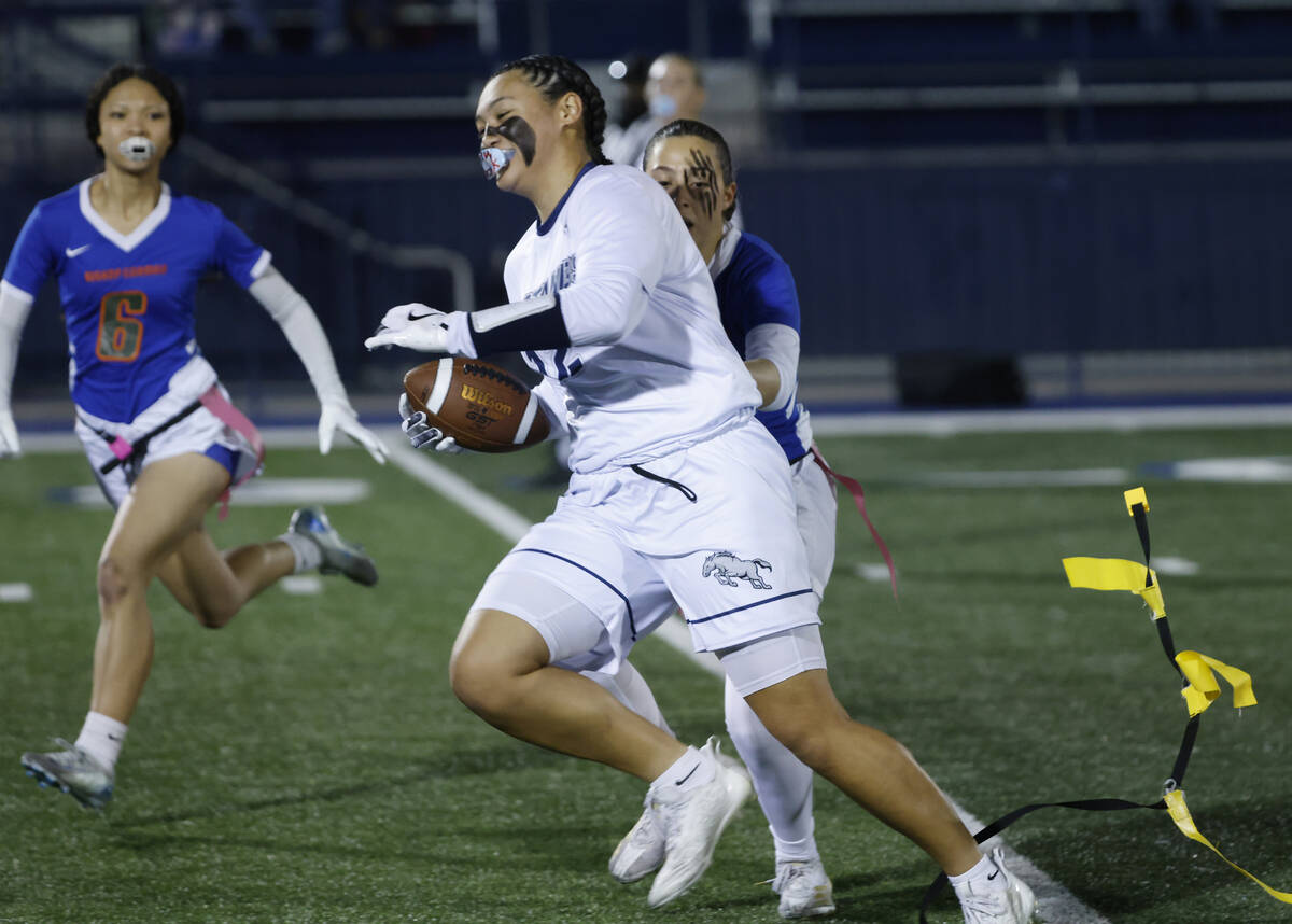 Shadow Ridge's Jaylani Palmer (12) gets her flags pulled by Bishop Gorman's defensive ...