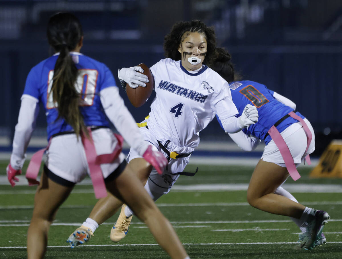 Shadow Ridge's running back Presley Walker (4) evades a flag pull on a run by Bishop Gorma ...
