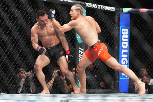 Michael Chandler, left, and Paddy Pimblett battle during a mixed martial arts fight at UFC 314, ...