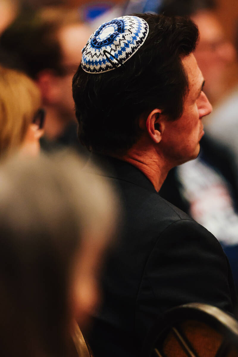 People listen as Yair Horn speaks about his experience being held hostage by Hamas at Congregat ...