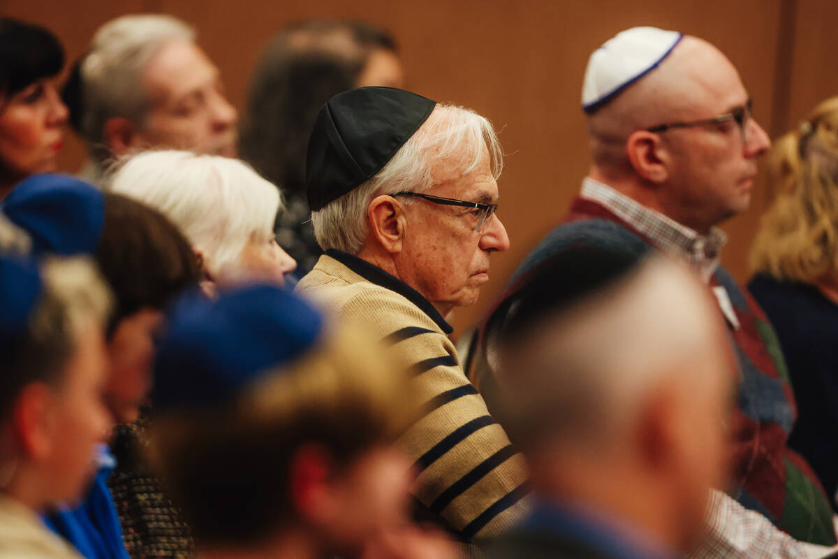People listen as Yair Horn speaks about his experience being held hostage by Hamas at Congregat ...