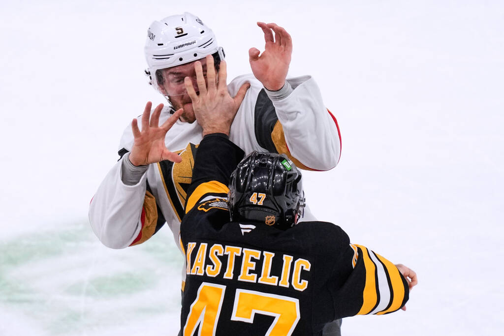 Vegas Golden Knights defenseman Jeremy Lauzon, rear, fights Boston Bruins center Mark Kastelic ...