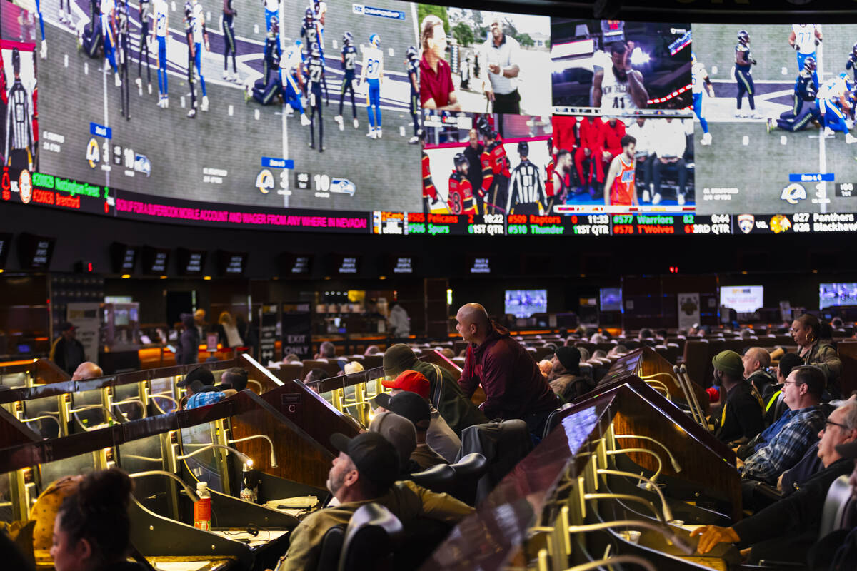 Bettors watch the NFC championship football game between the Rams and the Seahawks at the Westg ...