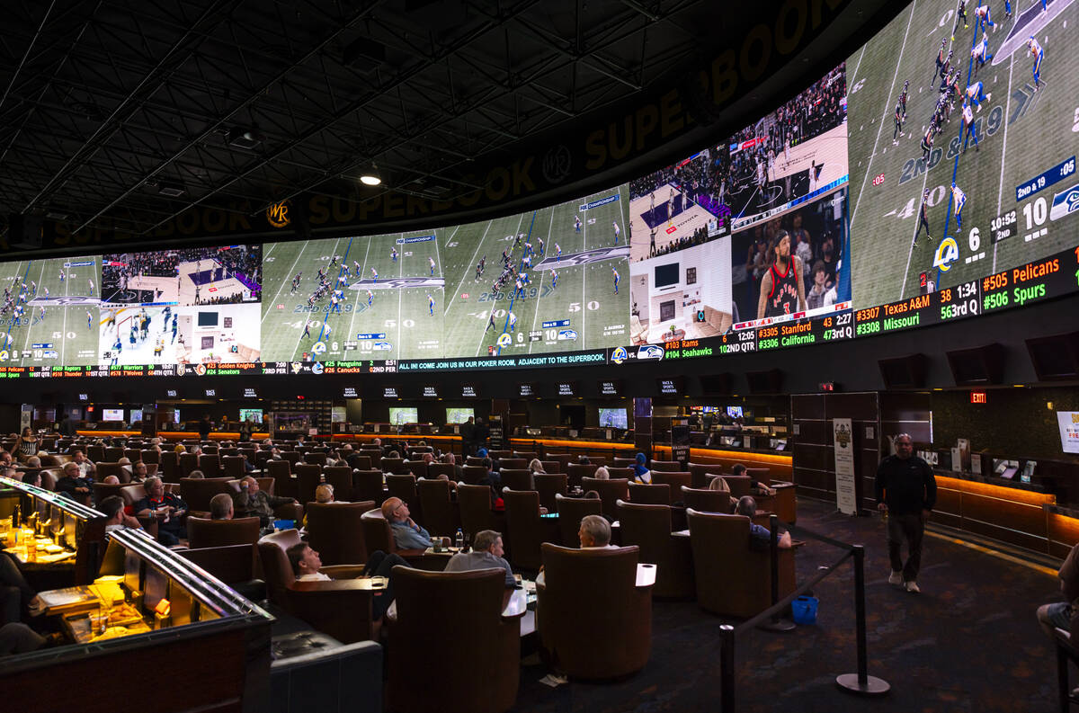 Bettors watch the NFC championship football game between the Rams and the Seahawks at the Westg ...