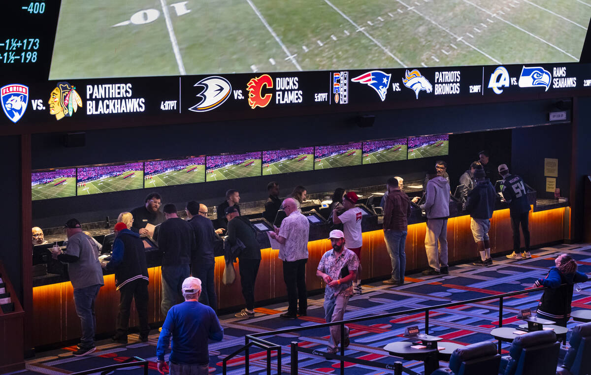 Bettors make wagers before the start of the AFC championship football game between the Broncos ...