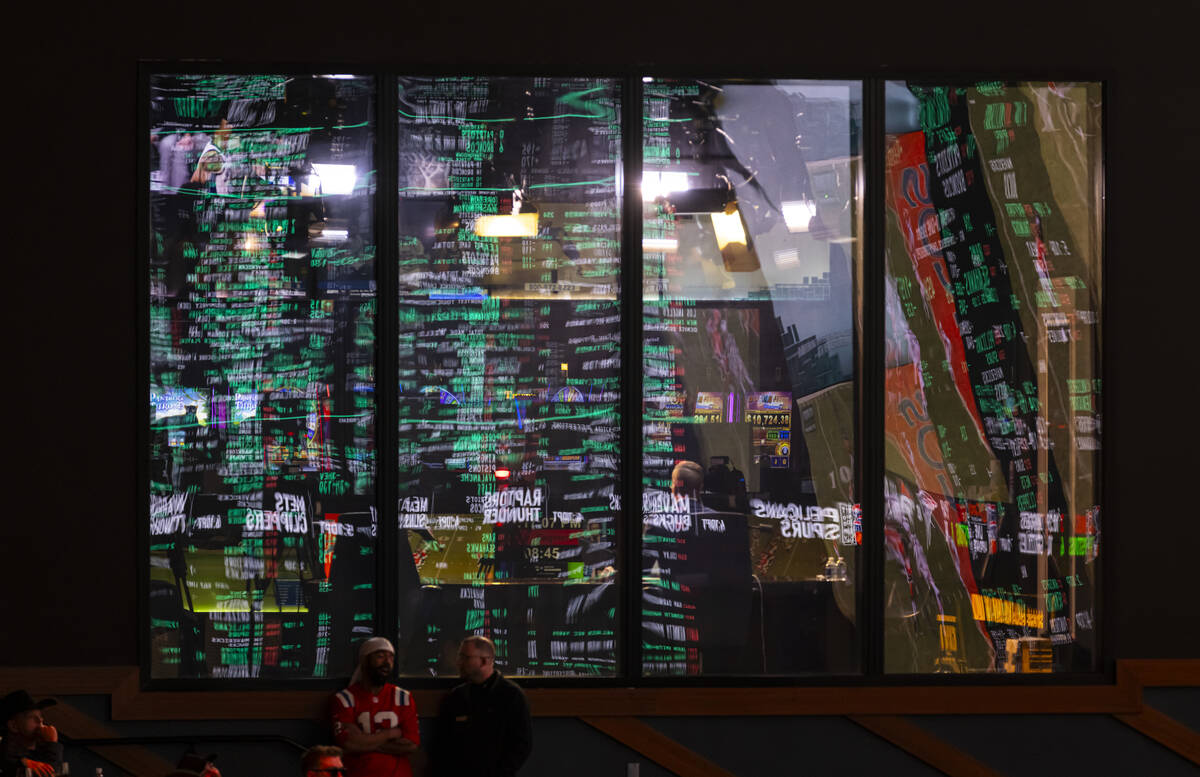 Betting lines are reflected in the windows of the Vegas Sports Information Network studio durin ...