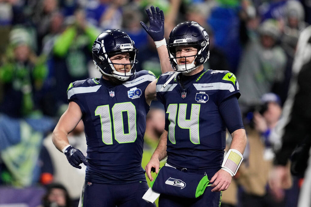 Seattle Seahawks quarterback Sam Darnold (14) is congratulated by wide receiver Cooper Kupp (10 ...