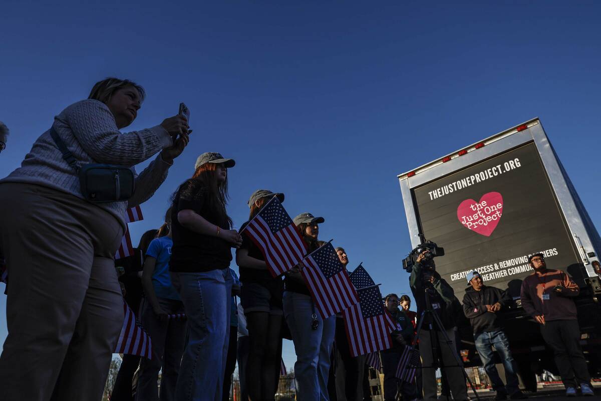 Attendees listen to remarks before a semi-truck carrying approximately 40,000 pounds of Church- ...