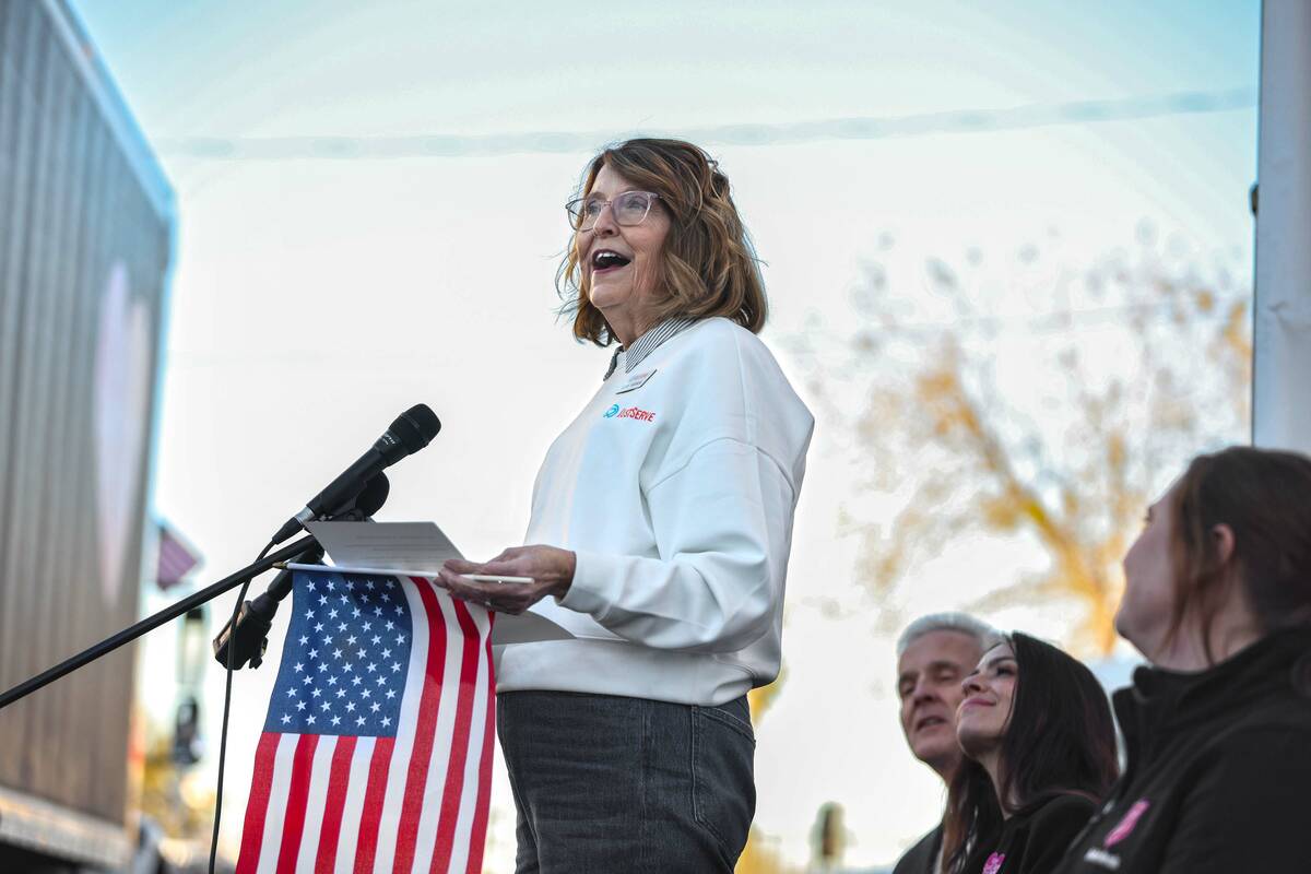 Elise Noorda with JustServe speaks before the start of an event highlighted by the unloading of ...