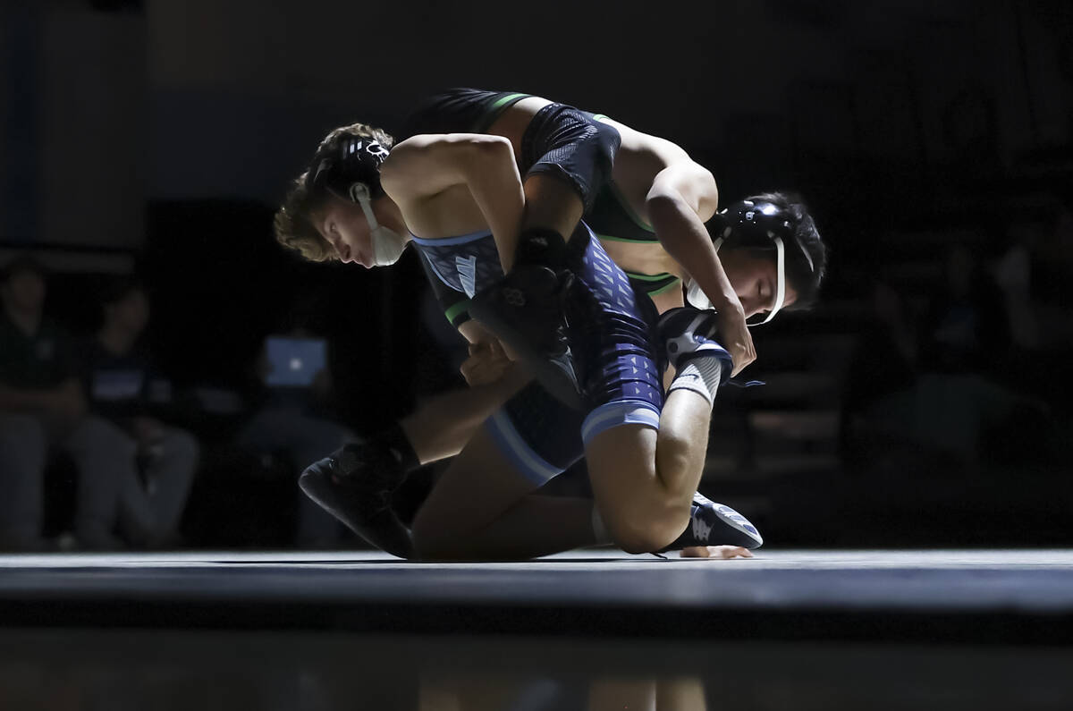Centennial’s Lorenzo Dukes, left, competes against Green Valley’s Angel Arguello ...