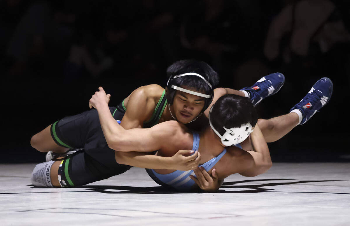 Green Valley’s Treyzten Gabrillo, left, competes against Centennial’s Cruz Rios d ...