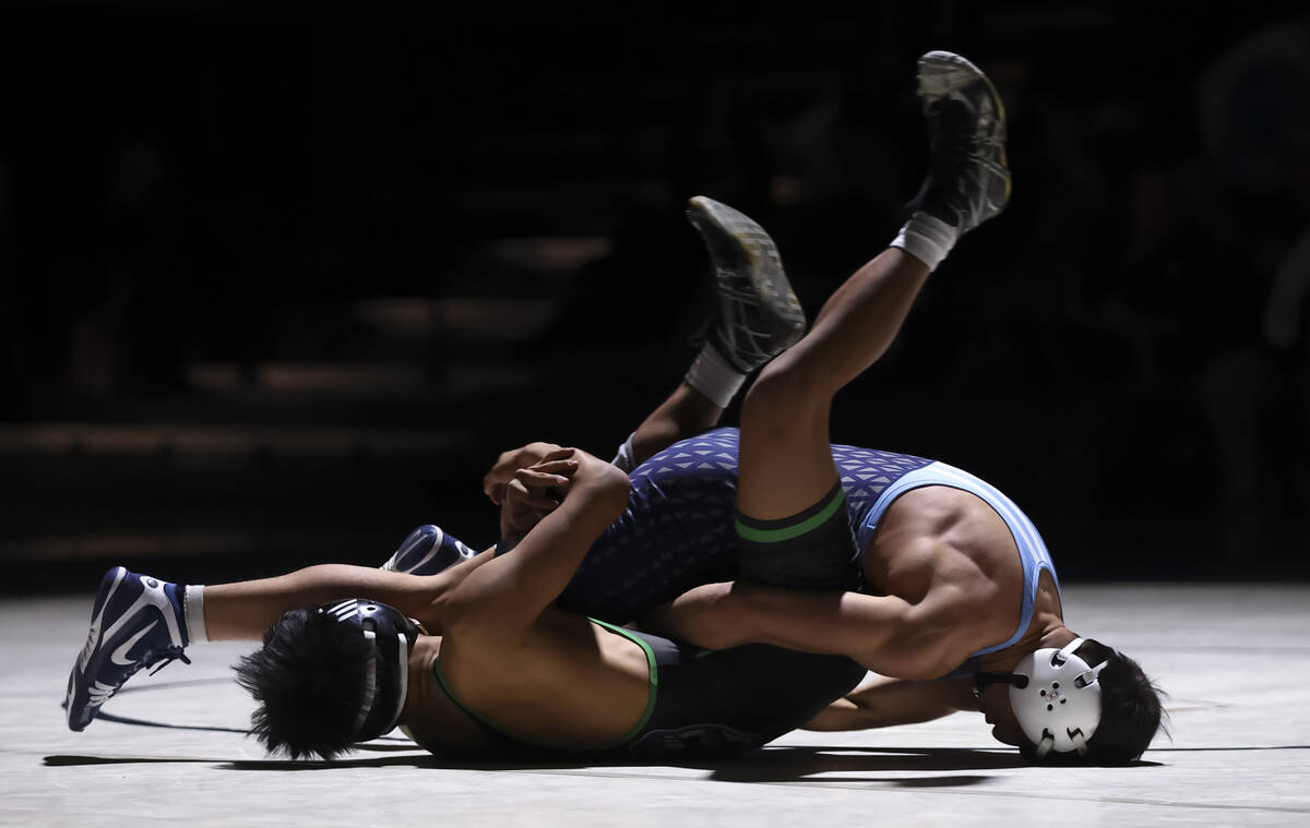 Green Valley’s Treyzten Gabrillo, left, competes against Centennial’s Cruz Rios d ...