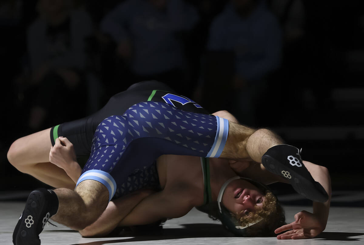 Green Valley’s Joshua Huslig, below, competes against Centennial’s David Chapla d ...