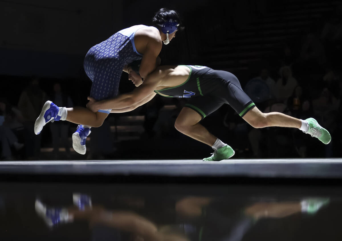 Green Valley’s Matthew Stosek, right, competes against Centennial’s Caleb Chargua ...