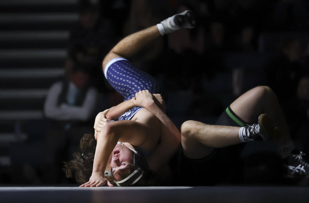 Green Valley’s Daniel Leal, obscured, competes against Centennial’s Joseph Dacko ...