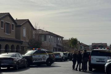 Police investigate the deaths of two people Wednesday, Jan. 28, 2026, in a residence in the 860 ...