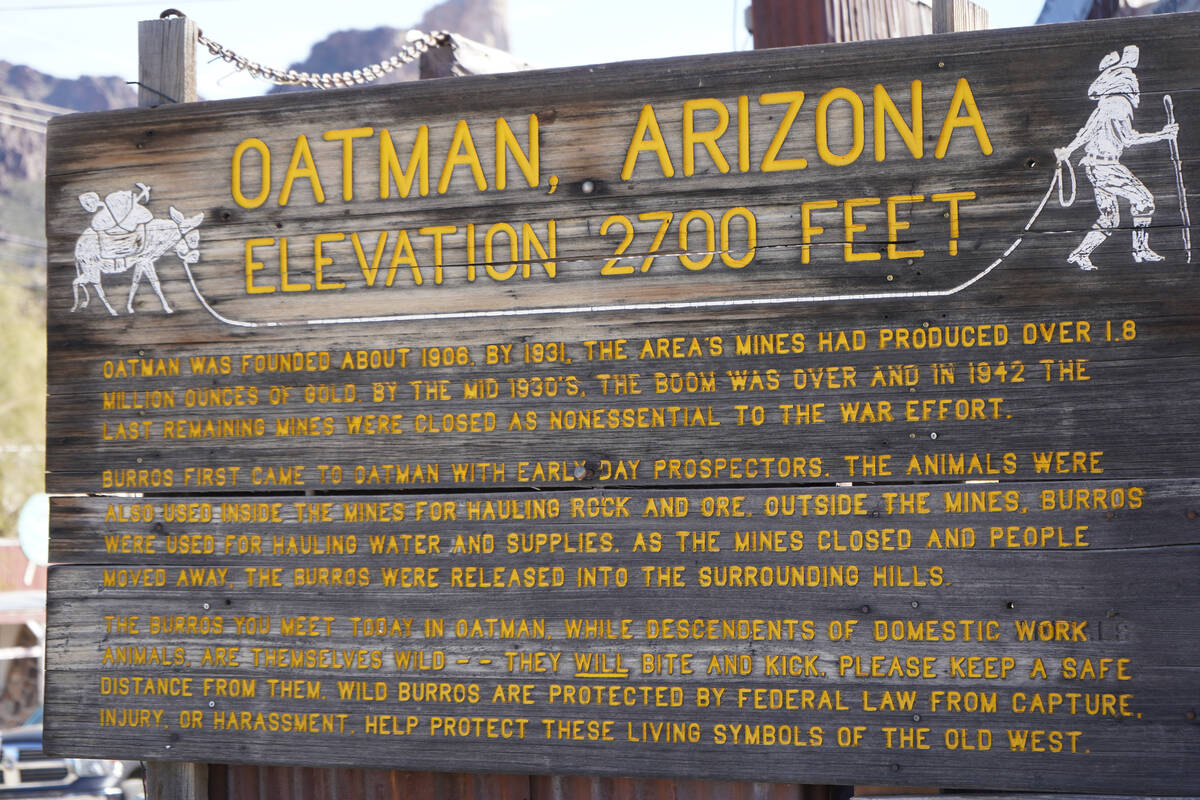 An Oatman sign tells of the town’s mining history and shares information about the area& ...