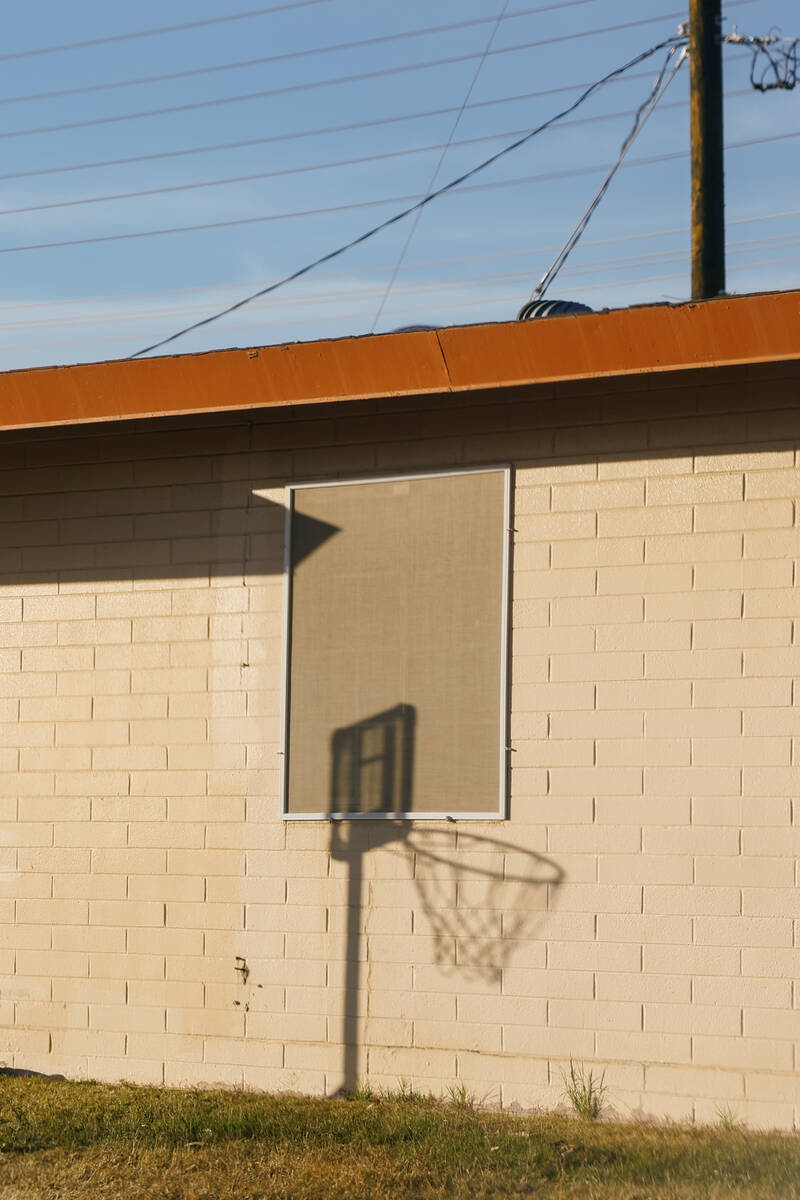 A basketball hoop casts a shadow across one of the homes in the Marble Manor public housing com ...