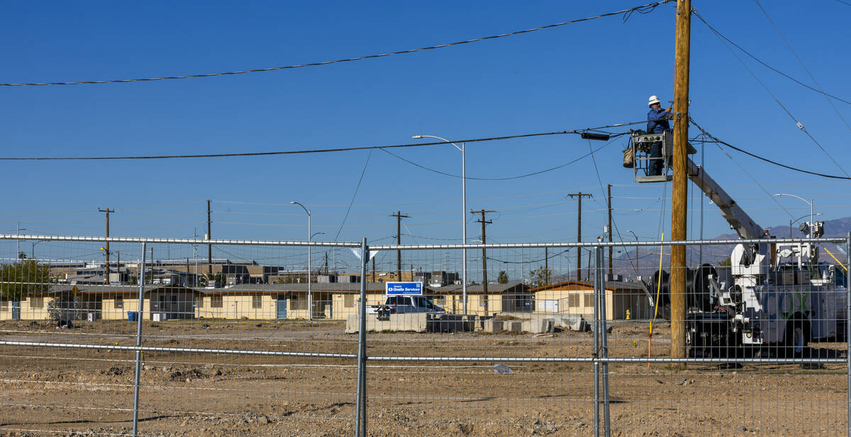 A Cox Cable crew works on the cleared land about the Marble Manor public housing complex, a por ...