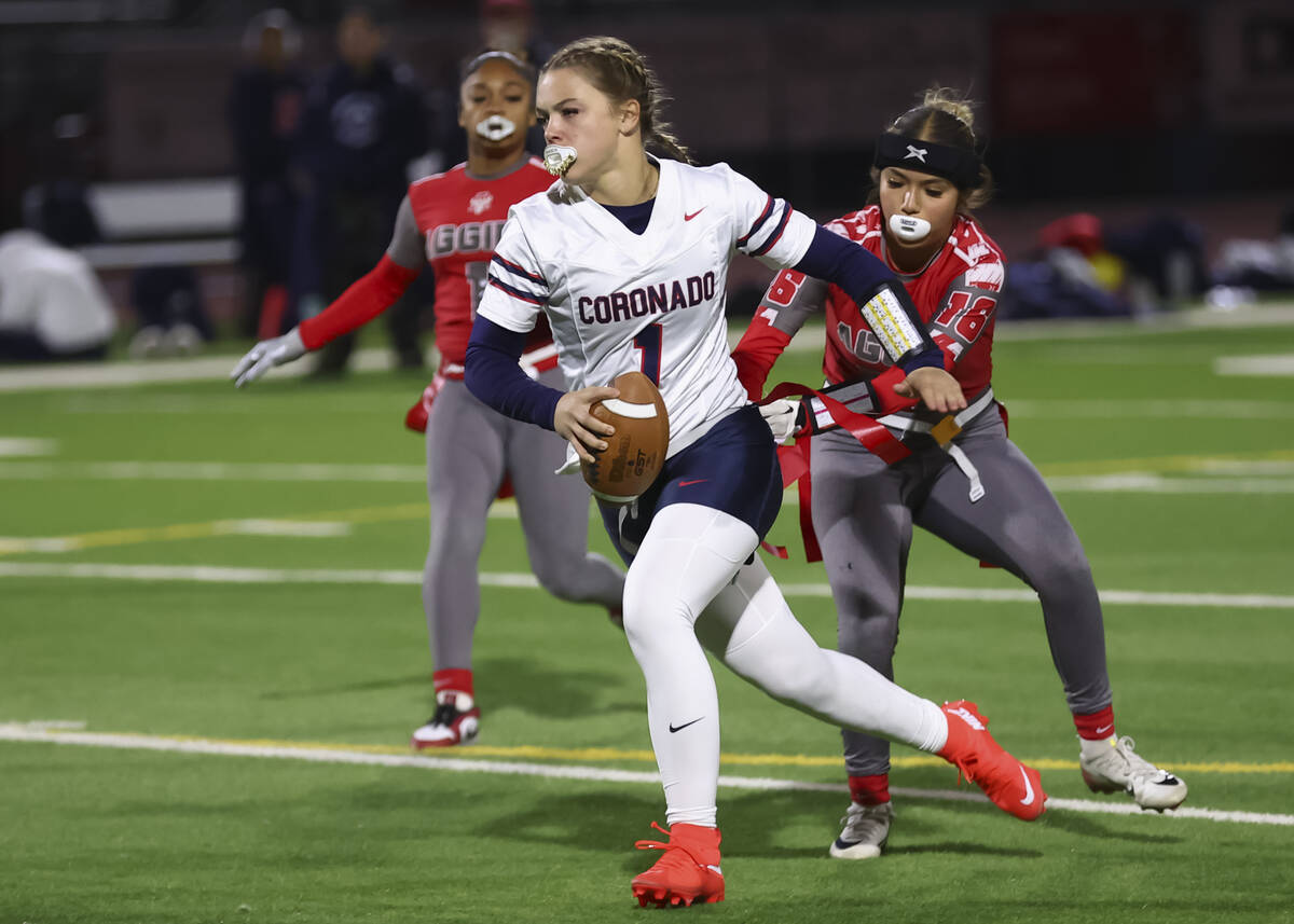 Coronado’s Bailey Goldberg (1) runs the ball as Arbor View’s Mia Rojas (16) reach ...