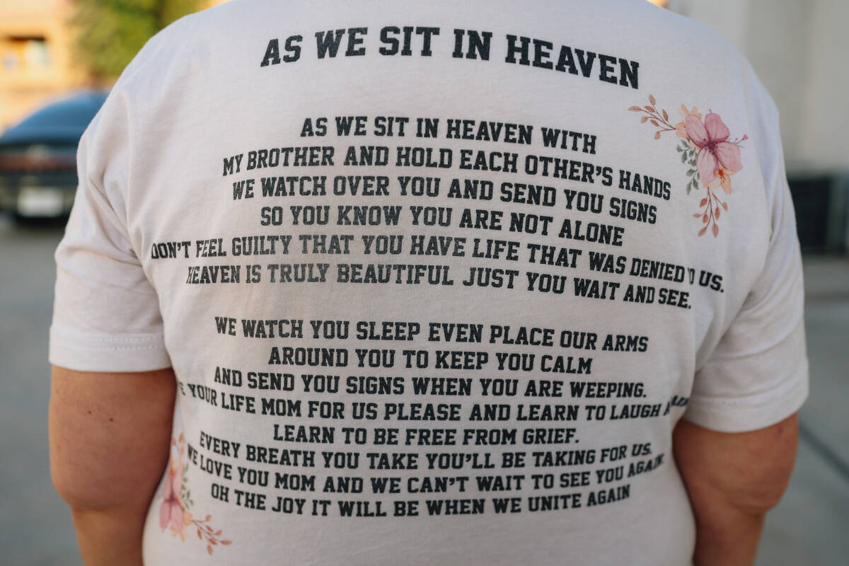 Cheri Brown shows off the back of her shirt which includes a poem she wrote for her daughter, A ...