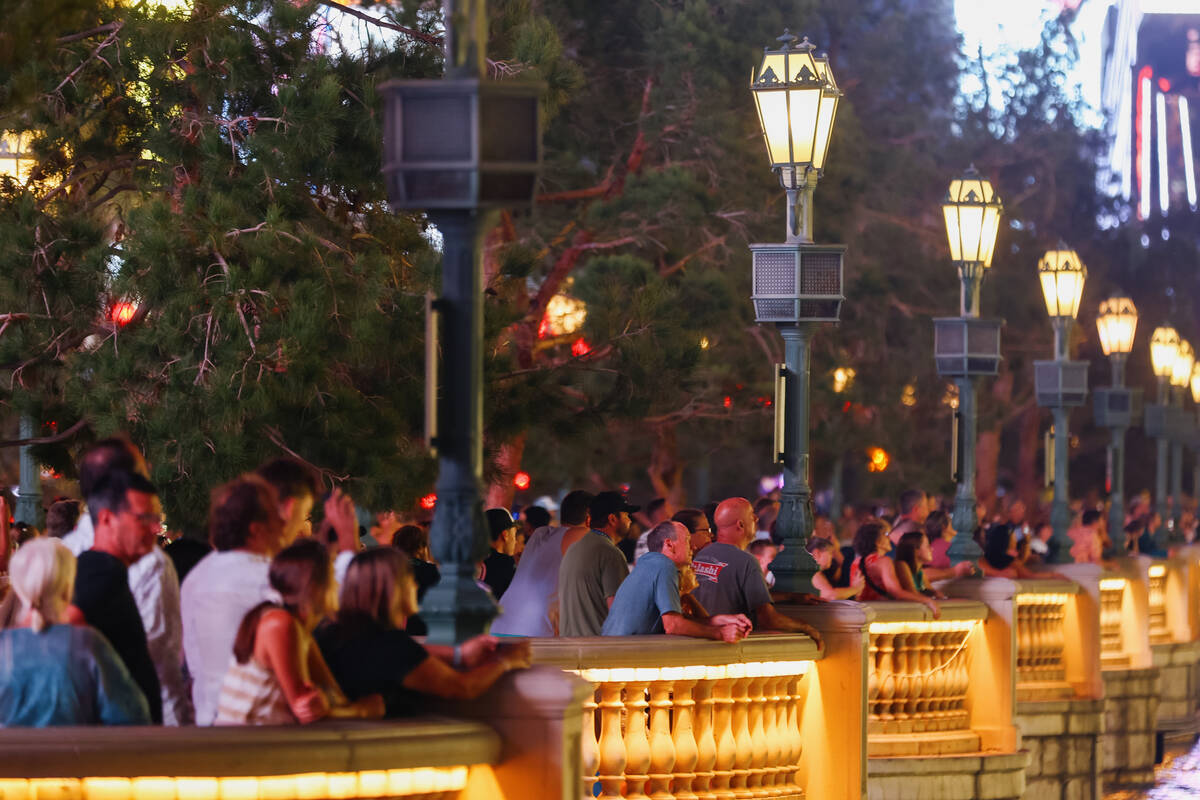 Tourists watch the fountains go off to the tune of “Luck Be a Lady” by Frank Sinatra in fro ...