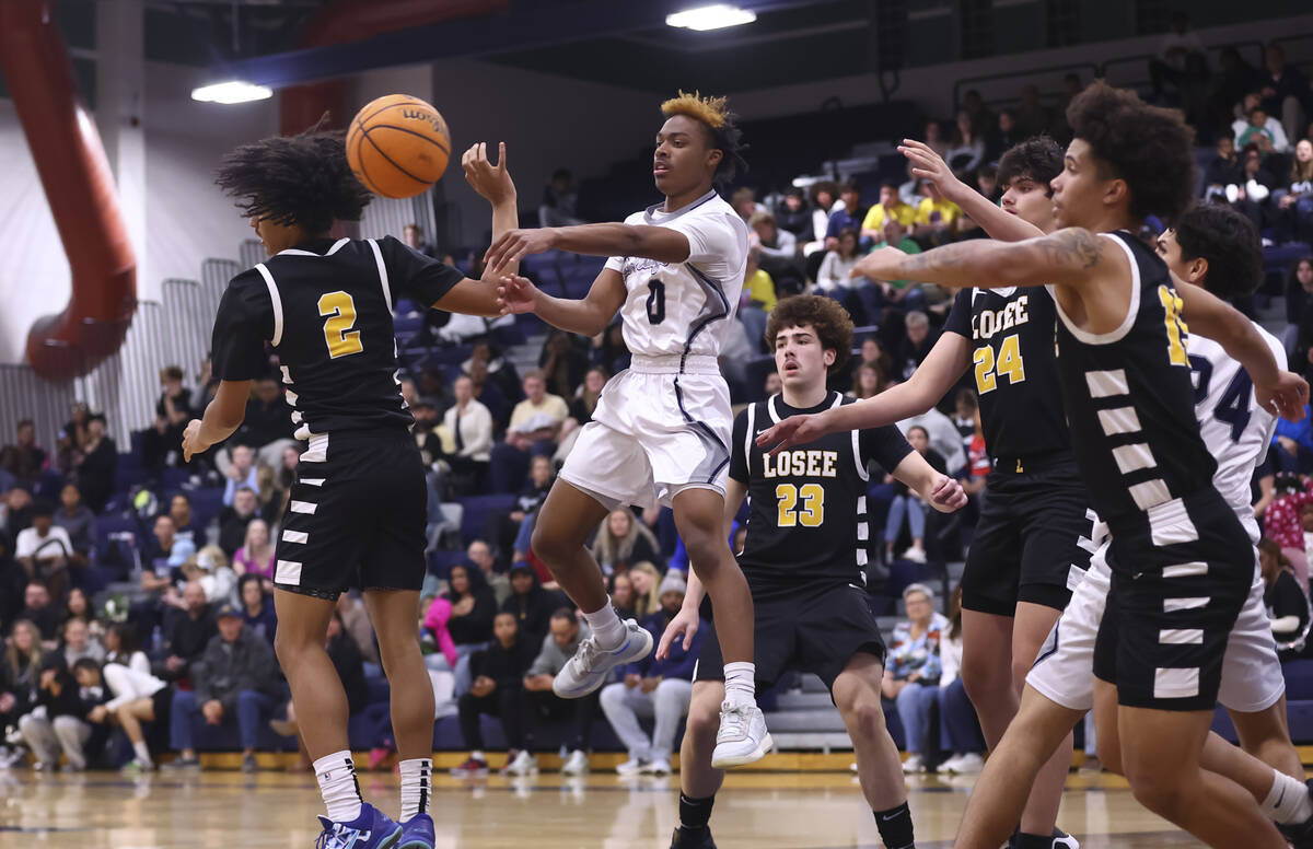 Shadow Ridge guard Terrence Lee (0) sends the ball past Losee’s Isaiah Woodson (2) durin ...