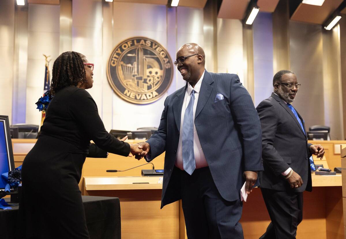 Chaplain Michael D. Thrower, right, receives the Spiritual Community Award from Councilwoman Sh ...