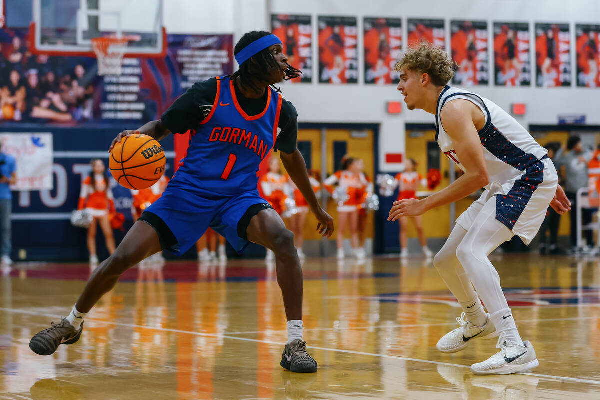 Bishop Gorman guard Ty Johnson (1) dribbles around Liberty guard Tayshawn Caesar (3) during the ...