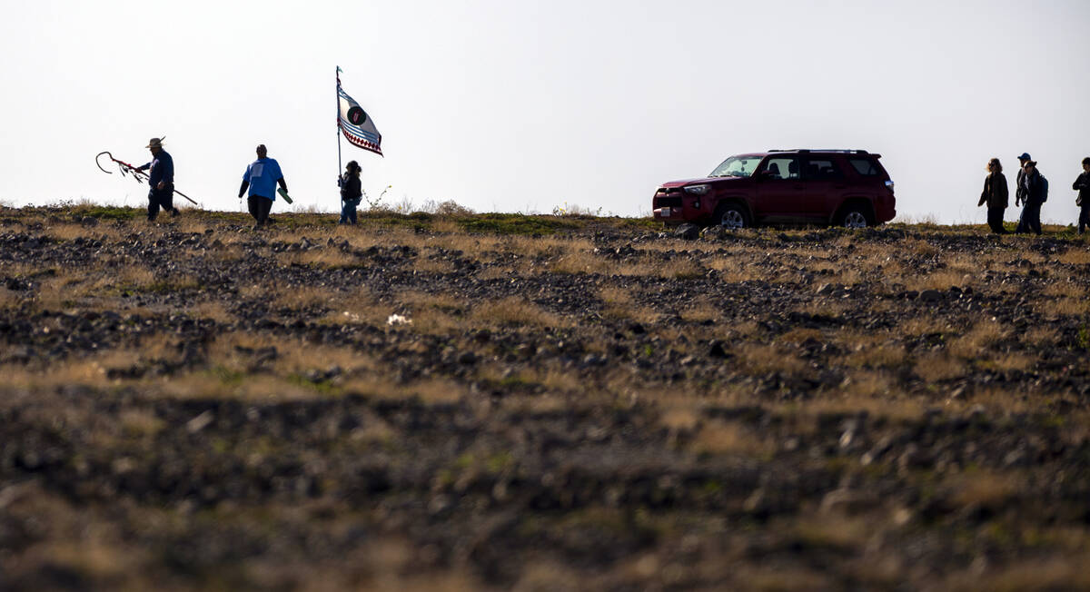 Trevor Stevens, Jeremiah Jones and Candy Leon of Elko walk to the starting point as the Timbish ...