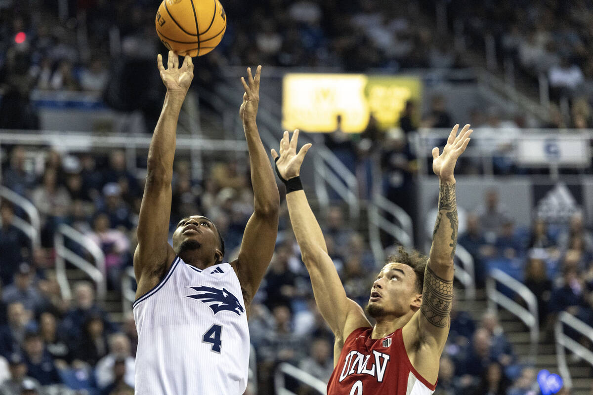 UNLV guard Dra Gibbs-Lawhorn (0) tries to defend UNR guard Corey Camper Jr. (4) during their ga ...