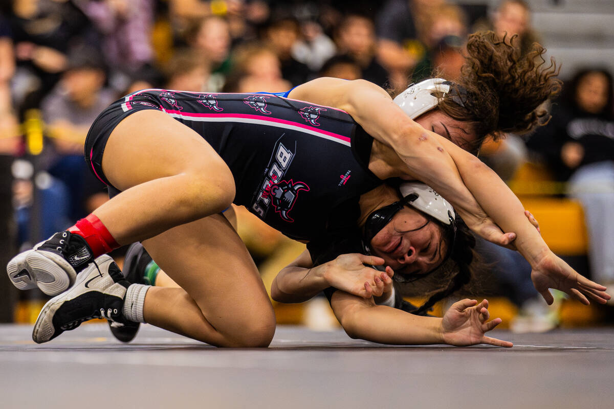 SLAM! Nevada wrestler Kaliya Klise, bottom, is pinned by Green Valley wrestler Melanie Ortiz du ...