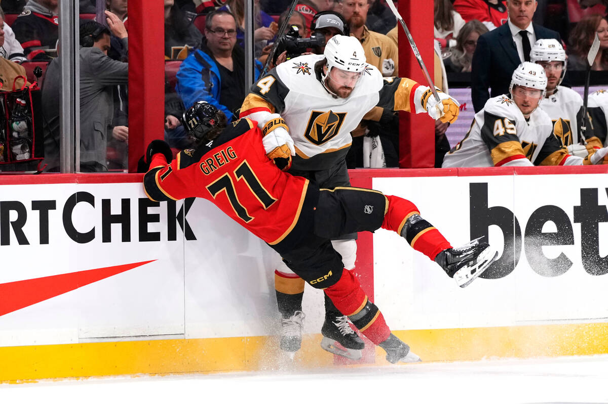 Ottawa Senators' Ridly Greig (71) and Vegas Golden Knights' Rasmus Andersson (4) coll ...