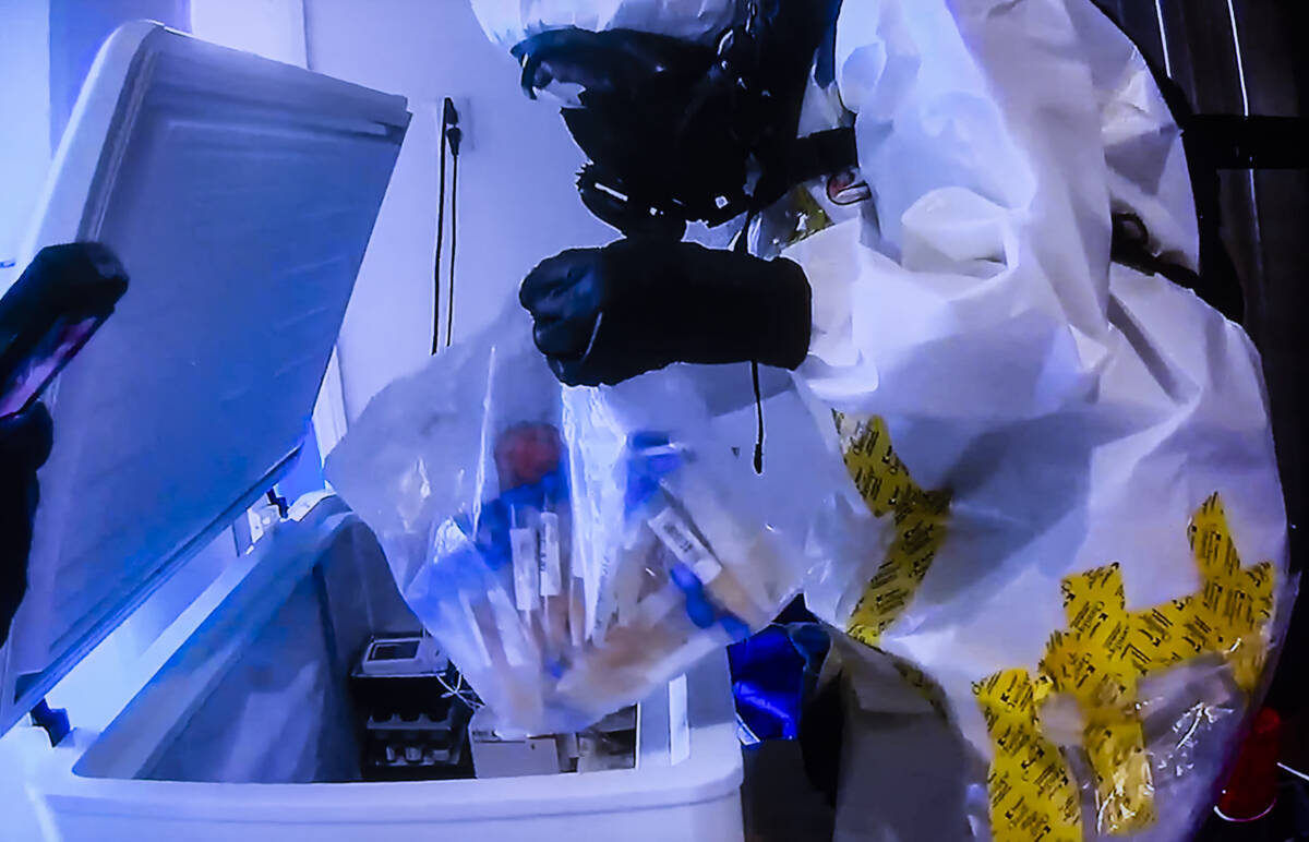 Footage of investigators looking through refrigerators containing vials of unknown substances i ...