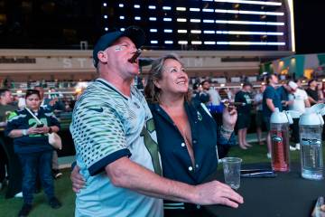 Seattle Seahawks fans Dan and Laura, of Seattle, watch the action during a Super Bowl 60 watch ...