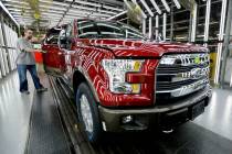 FILE - A worker inspects a new aluminum-alloy body Ford F-150 truck at the company's Kansa ...