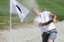 SPORTS - Rebel golfer Andres Gonzales watches his ball fly of the sand on to the ninth-hole gre ...