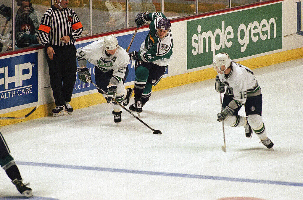Hartford Whalers defenseman Glen Wesley (20) heads the puck away from the board Anaheim Mighty ...