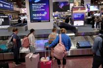 Passengers pick up their luggage in Terminal 1 at Harry Reid International Airport in Las Vegas ...