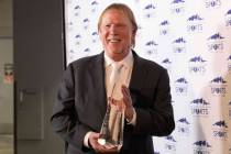 Raiders owner Mark Davis holds up his trophy received following his induction ceremony to the S ...