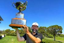 Phil Reedy holds up the championship trophy after winning the Nevada State Amateur Championship ...