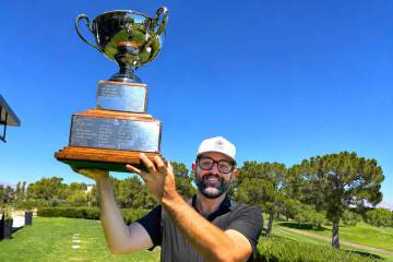 Phil Reedy holds up the championship trophy after winning the Nevada State Amateur Championship ...