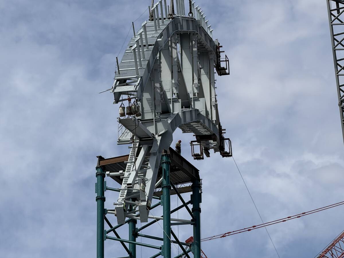 A portion of the second roof truss being lifted into place by construction workers at the Athle ...
