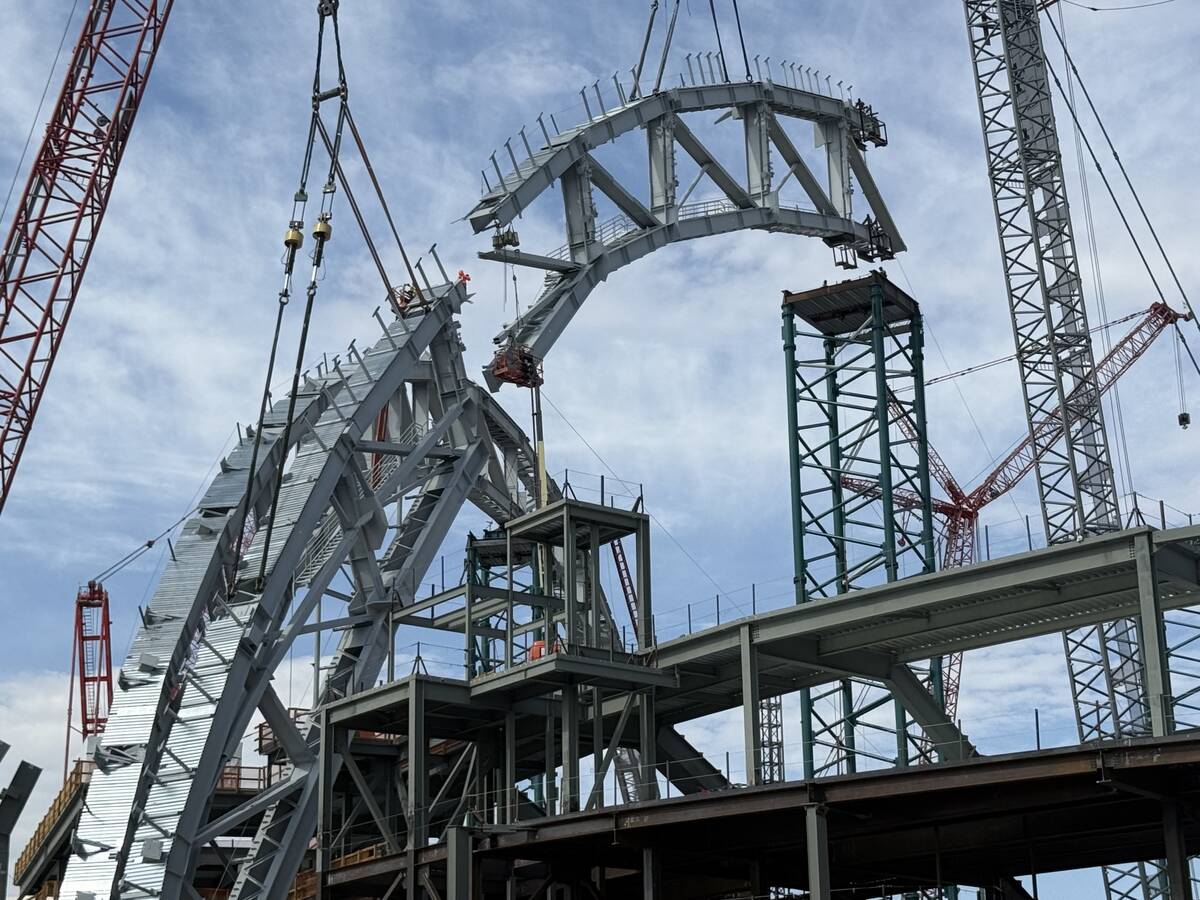 A portion of the second roof truss being lifted into place by construction workers at the Athle ...