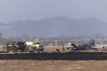 Crews work to douse a F-35 fighter jet that crashed near the run way at Marine Corps Air Statio ...