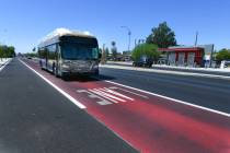 A bus travels in a combination bus and bike lane on Maryland Parkway across the street from a n ...